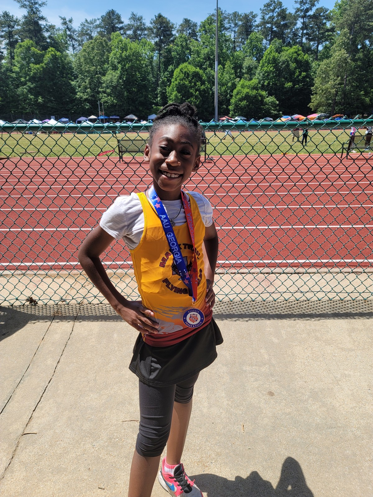 Samiya wearing medals beside the track